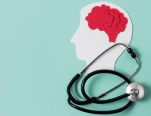 silueta de una cabeza, con el cerebro en rojo y un estetoscopio real encima